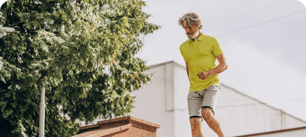 Healthy senior man walking up stairs outdoors, staying active and fit with ease