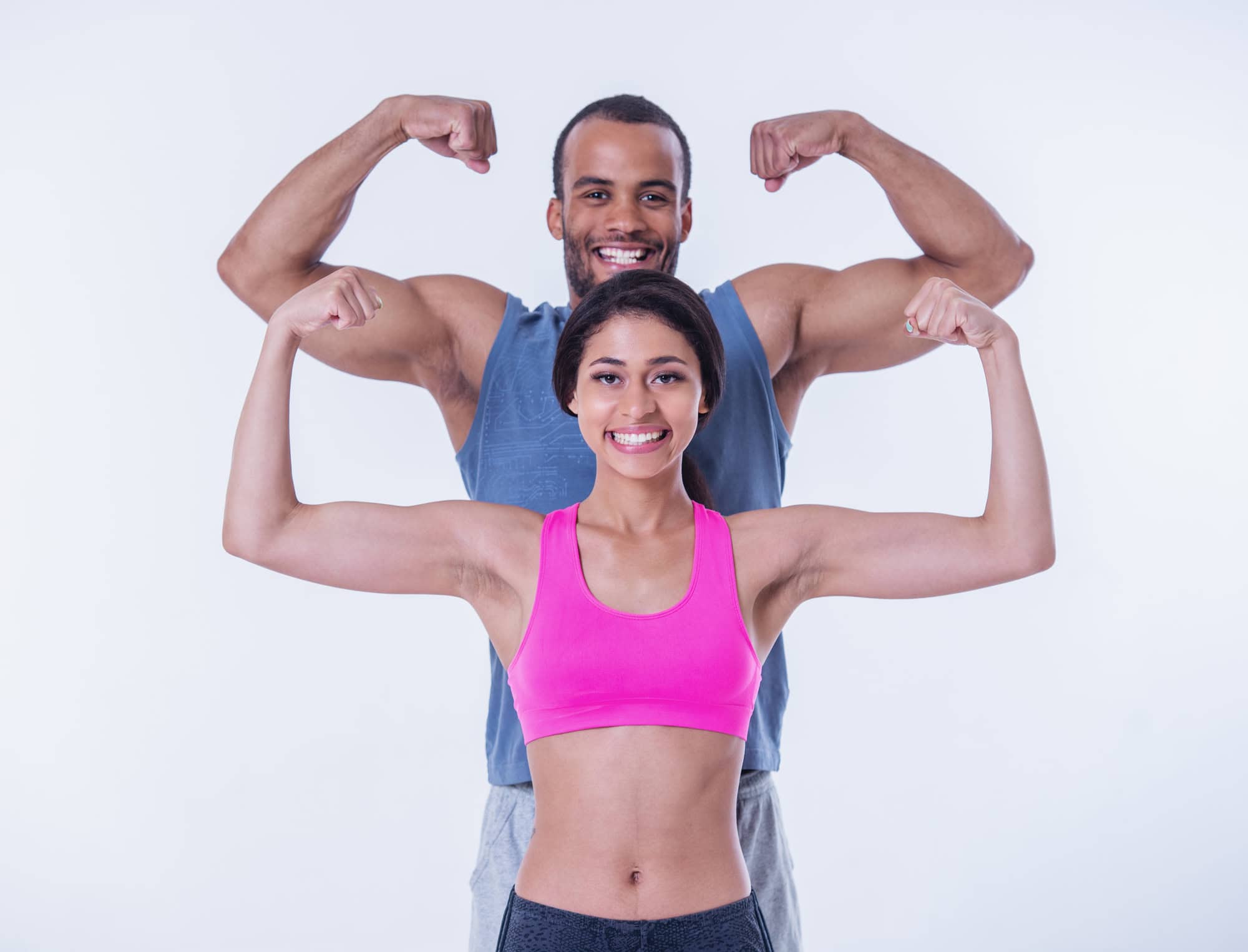 Happy athletic couple flexing muscles, symbolising HueLight’s impact on strength, recovery, and vitality.