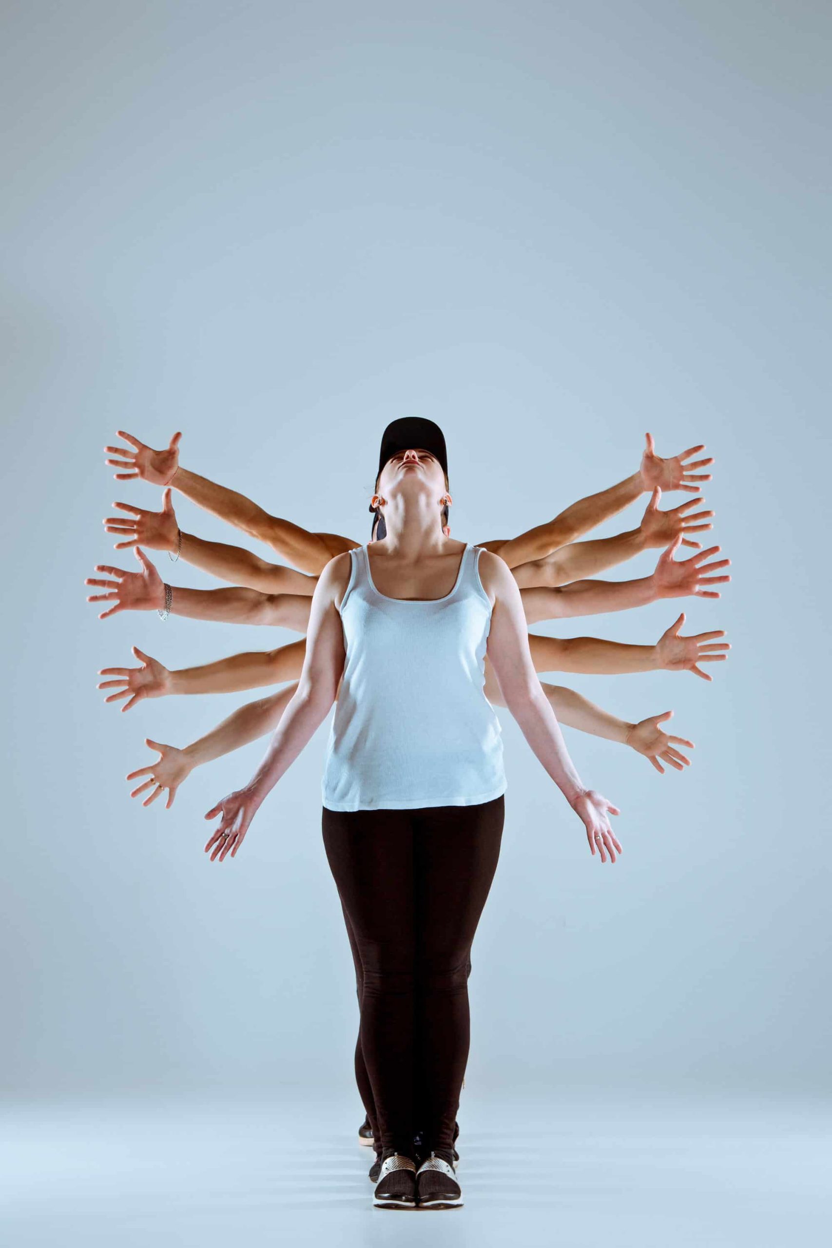 Woman in motion pose with extended arms representing energy flow and full-body activation, mirroring HueLight’s cellular stimulation approach.